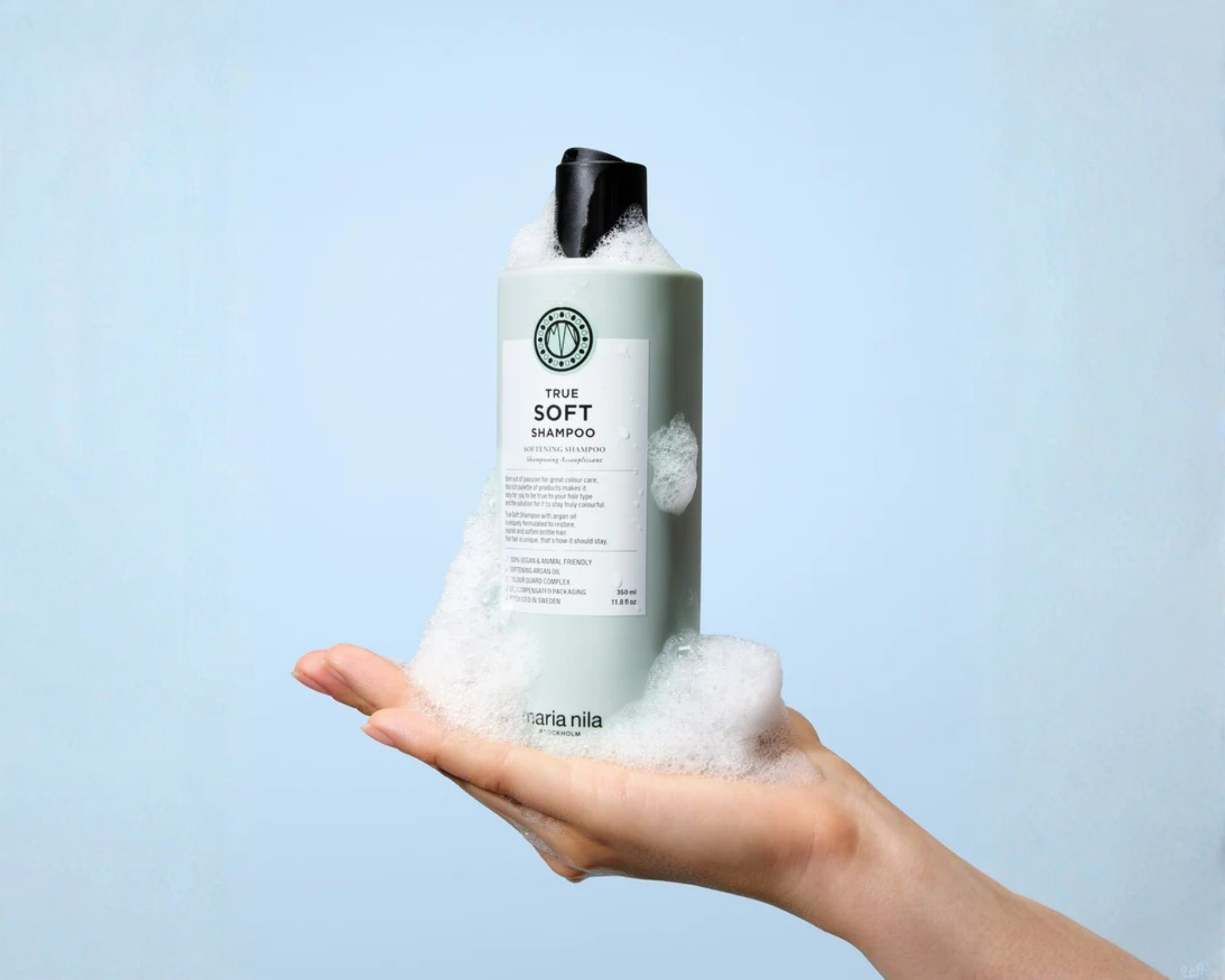 Maria Nila True Soft Shampoo bottle with foam in hand, hydrating vegan shampoo for dry hair