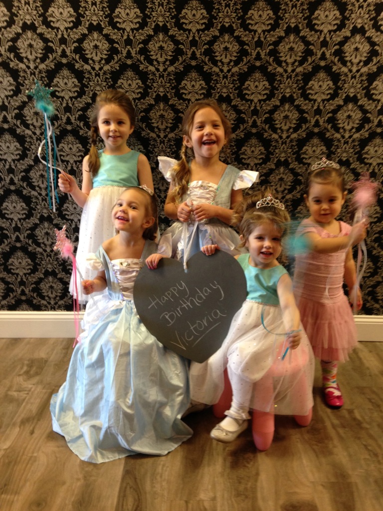 Children celebrating a birthday with princess hairstyles