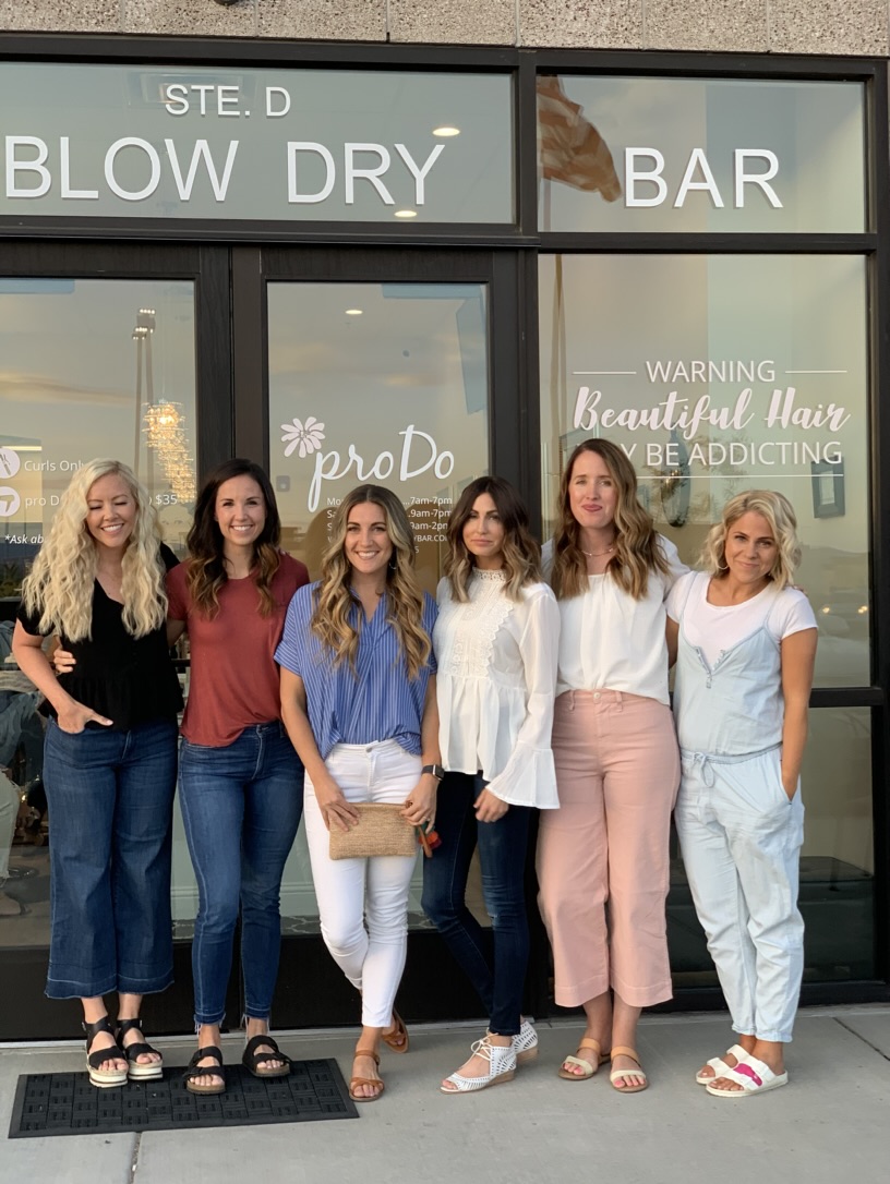Group posing outside a pro Do salon