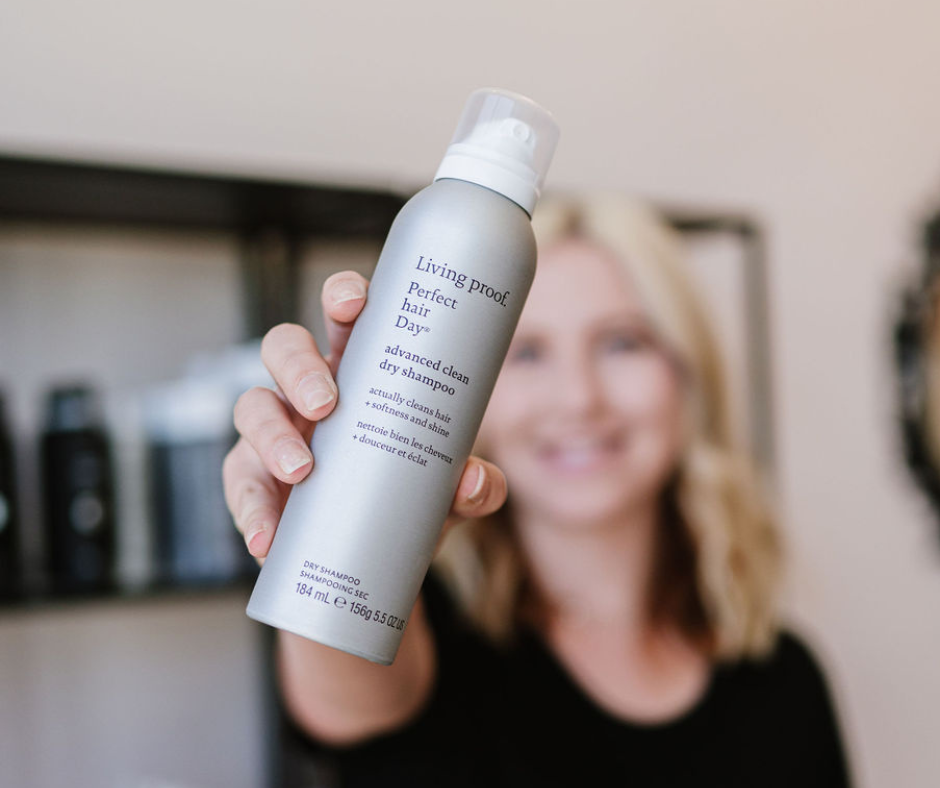Stylist holding Living Proof Advanced Clean Dry Shampoo at Pro Do Blow Dry Bar